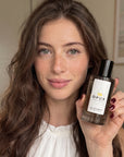 Female customer holding an OPUX perfume bottle
